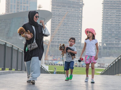 Family with small dogs walking in Downtown Dubai