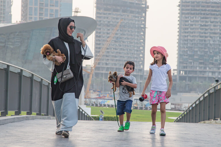 Family with small dogs walking in Downtown Dubai