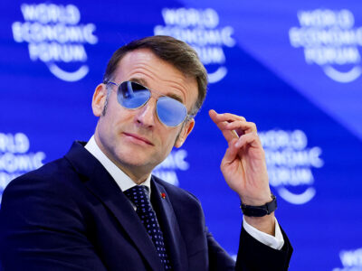French President Macron wearing sunglasses indoors at Davos